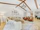 Vaulted living room with beams, a modern chandelier, and lots of natural light creates a welcoming atmosphere at 1115 Berry Ridge Rd, Charlotte, NC 28270