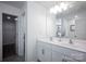 Bright bathroom with double sink vanity, white cabinetry, and separate toilet and shower room at 116 Kingsway Dr, Mooresville, NC 28115