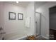 Well-lit bathroom featuring a soaking tub, glass-enclosed shower, and modern fixtures at 116 Kingsway Dr, Mooresville, NC 28115