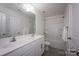 This bright bathroom has a double sink vanity, framed mirror and shower-tub at 116 Kingsway Dr, Mooresville, NC 28115
