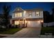 Charming two-story home with stone accents, blue shutters, and a well-manicured front lawn at 116 Kingsway Dr, Mooresville, NC 28115
