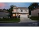 Charming two-story home with stone accents, blue shutters, and a well-manicured front lawn at 116 Kingsway Dr, Mooresville, NC 28115