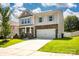 Charming home featuring light blue shutters, manicured lawn, and two-car garage at 116 Kingsway Dr, Mooresville, NC 28115