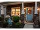 Inviting front porch with decorative blue door, stone accents, and a welcoming atmosphere at 116 Kingsway Dr, Mooresville, NC 28115
