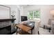 Bright home office with fireplace, large window, and ample desk space at 116 Kingsway Dr, Mooresville, NC 28115