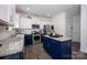 Modern kitchen featuring white cabinets, navy blue island, stainless appliances, and granite counters at 116 Kingsway Dr, Mooresville, NC 28115