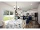 Bright kitchen with white cabinets, blue island, and dining area, filled with natural light at 116 Kingsway Dr, Mooresville, NC 28115