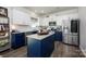 Modern kitchen featuring white cabinets, navy blue island, stainless appliances, and granite counters at 116 Kingsway Dr, Mooresville, NC 28115