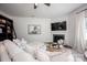 Well lit living room with fireplace, mounted television, and plush sofa at 116 Kingsway Dr, Mooresville, NC 28115