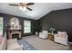 Comfortable main bedroom featuring a fireplace, seating area, and neutral decor for relaxation at 116 Kingsway Dr, Mooresville, NC 28115