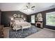 Elegant main bedroom with fireplace, decorative rug, ceiling fan and abundant natural light at 116 Kingsway Dr, Mooresville, NC 28115