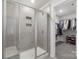Modern bathroom featuring a spacious walk-in shower and an organized walk-in closet at 135 Orson Oaks Ln, Pineville, NC 28134