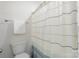 Clean bathroom with a white toilet and a shower featuring a patterned curtain at 135 Orson Oaks Ln, Pineville, NC 28134