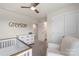 Bright Bedroom showcasing a crib, dresser, and an adjacent bathroom at 135 Orson Oaks Ln, Pineville, NC 28134