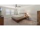 Bright bedroom with neutral tones, a ceiling fan, and carpet at 135 Orson Oaks Ln, Pineville, NC 28134