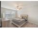 Cozy bedroom with a comfortable bed, neutral tones, and great natural light at 135 Orson Oaks Ln, Pineville, NC 28134