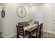 Dining room features a modern table, six chairs, stylish clock decor, and natural light at 135 Orson Oaks Ln, Pineville, NC 28134