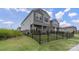 Gray siding two-story home featuring a landscaped yard enclosed by black metal fence at 135 Orson Oaks Ln, Pineville, NC 28134
