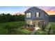 Charming home featuring stone accents, inviting front porch, landscaped yard, and a decorative black metal fence at 135 Orson Oaks Ln, Pineville, NC 28134