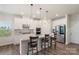 Bright kitchen features stainless appliances, stone counters, pendant lights, and bar stool seating at 135 Orson Oaks Ln, Pineville, NC 28134