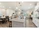 Bright kitchen features stainless appliances, stone counters, pendant lights, and an open floor plan at 135 Orson Oaks Ln, Pineville, NC 28134