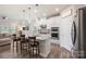 Bright kitchen features stainless appliances, stone counters, pendant lights, and bar stool seating at 135 Orson Oaks Ln, Pineville, NC 28134