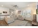 Comfortable living room with a large sectional sofa, ceiling fan and a view of the staircase at 135 Orson Oaks Ln, Pineville, NC 28134