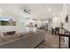 Open living room with white kitchen, stainless steel appliances, and breakfast bar at 135 Orson Oaks Ln, Pineville, NC 28134