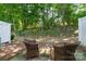 Secluded backyard seating area nestled among trees, providing a private and serene outdoor space at 14755 Lions Paw St, Charlotte, NC 28273