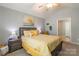 Bedroom with vaulted ceilings, coordinated lamps, and soft yellow bedding at 14755 Lions Paw St, Charlotte, NC 28273
