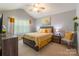 Sun-filled bedroom with vaulted ceilings, soft carpet, neutral walls, and coordinated décor at 14755 Lions Paw St, Charlotte, NC 28273