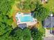 Aerial view of a community pool with lounge chairs, surrounded by lush greenery and well-maintained landscaping at 14755 Lions Paw St, Charlotte, NC 28273