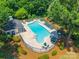 Aerial shot of a community pool area with lounge chairs, tables, and green landscaping, creating an inviting recreational space at 14755 Lions Paw St, Charlotte, NC 28273