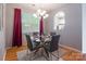 Contemporary dining room with a glass table, modern chairs, and large windows at 14755 Lions Paw St, Charlotte, NC 28273