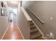 Inviting hallway features wood floors, stairs with carpet, and neutral paint, creating a warm and welcoming atmosphere at 14755 Lions Paw St, Charlotte, NC 28273