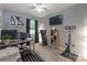 Well-lit home office featuring modern exercise equipment, shelving, and computer setup for a comfortable work and workout space at 14755 Lions Paw St, Charlotte, NC 28273