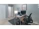 Comfortable home office boasts natural light, a modern desk setup, a black and white striped rug, and neutral wall paint at 14755 Lions Paw St, Charlotte, NC 28273