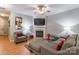 Stylish living room featuring a fireplace, ceiling fan, wood floors, and comfortable seating for relaxation and entertainment at 14755 Lions Paw St, Charlotte, NC 28273