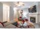 Comfortable living room with fireplace, ceiling fan, and neutral paint scheme at 14755 Lions Paw St, Charlotte, NC 28273