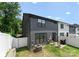 Well-maintained backyard with patio area and white fencing, ideal for outdoor living and entertaining at 1517 Falcon St, Charlotte, NC 28211