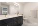 This bathroom features a double vanity, modern gold fixtures, and an ample mirror at 1517 Falcon St, Charlotte, NC 28211