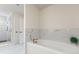 The bathroom features a modern tub with marble tile accents and glass shower at 1517 Falcon St, Charlotte, NC 28211
