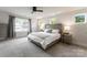 This bedroom features a ceiling fan, large windows, and neutral-toned decor at 1517 Falcon St, Charlotte, NC 28211