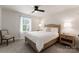 This bedroom features a neutral decor with large windows and a comfortable bed at 1517 Falcon St, Charlotte, NC 28211