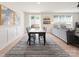 Open-concept dining room flowing into the living room, featuring a modern rug and plenty of natural light at 1517 Falcon St, Charlotte, NC 28211