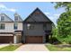 Charming two-story home featuring vertical siding, a stylish brown garage door, and inviting curb appeal at 1517 Falcon St, Charlotte, NC 28211