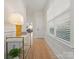Bright hallway with wainscoting, light wood floors, modern decor, and a window bringing in natural light at 1517 Falcon St, Charlotte, NC 28211