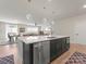 Spacious kitchen island with seating, stainless steel appliances, modern sink, and an open-concept design at 1517 Falcon St, Charlotte, NC 28211