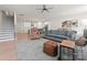 Open-concept living room with modern decor, including comfortable seating, a ceiling fan, and views of the kitchen at 1517 Falcon St, Charlotte, NC 28211