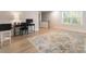 A bright home office with a large rug, a desk, a computer, and a window for natural light at 1517 Falcon St, Charlotte, NC 28211